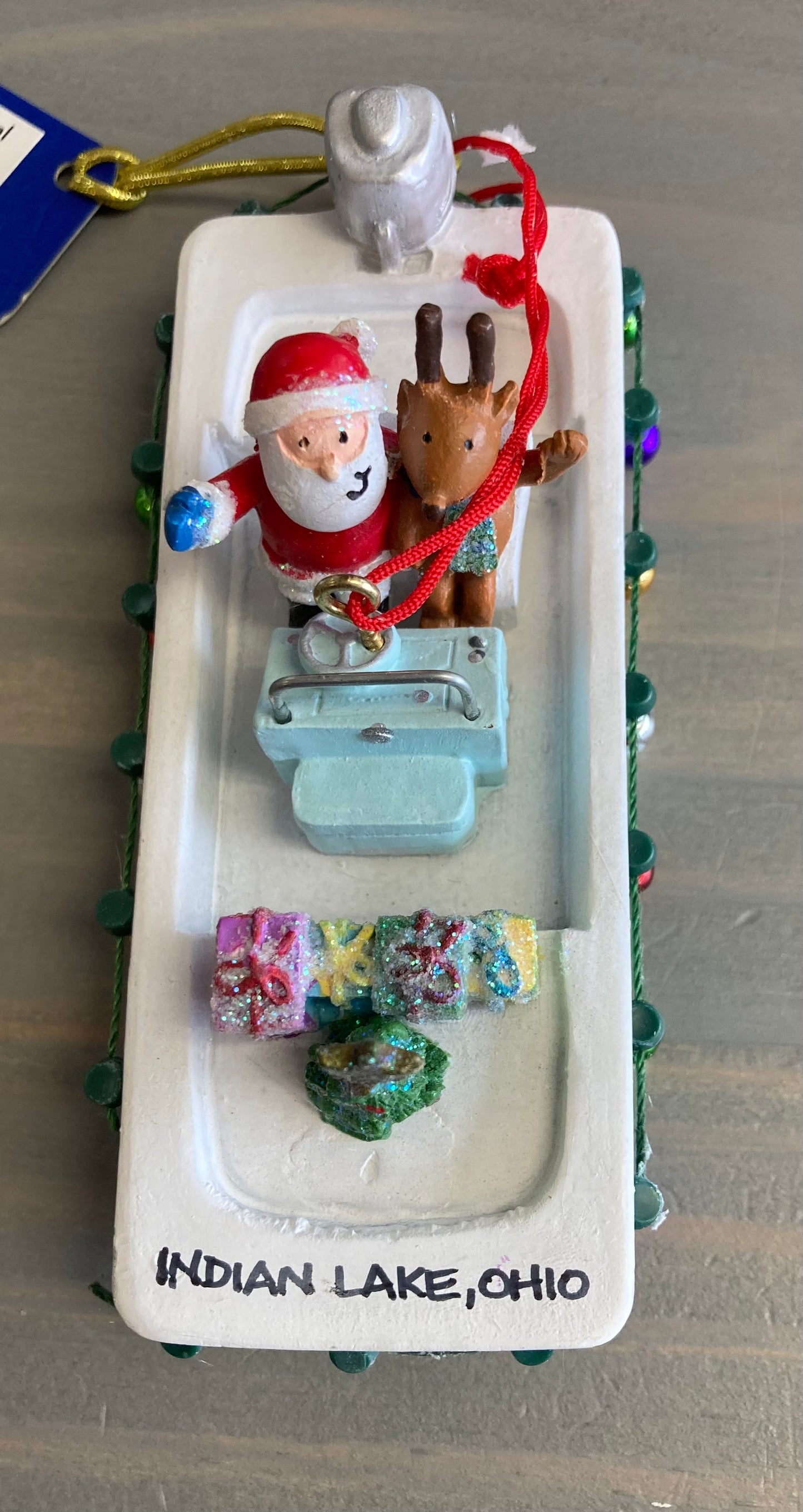 Santa in Skiff with Lights- Resin Ornament